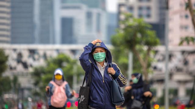 People wearing masks walking in the street