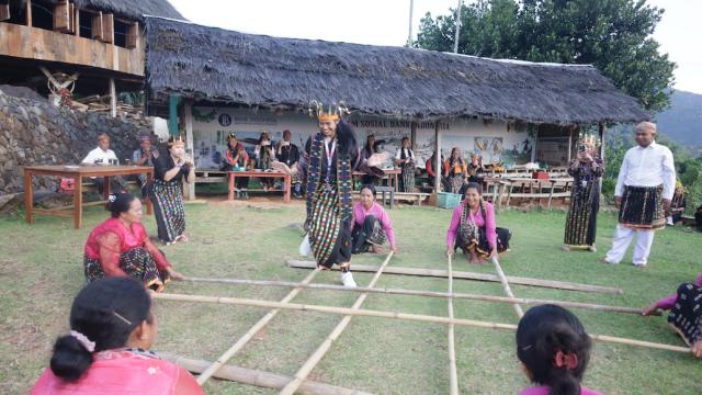 People trying out a traditional dance in Indonesia.