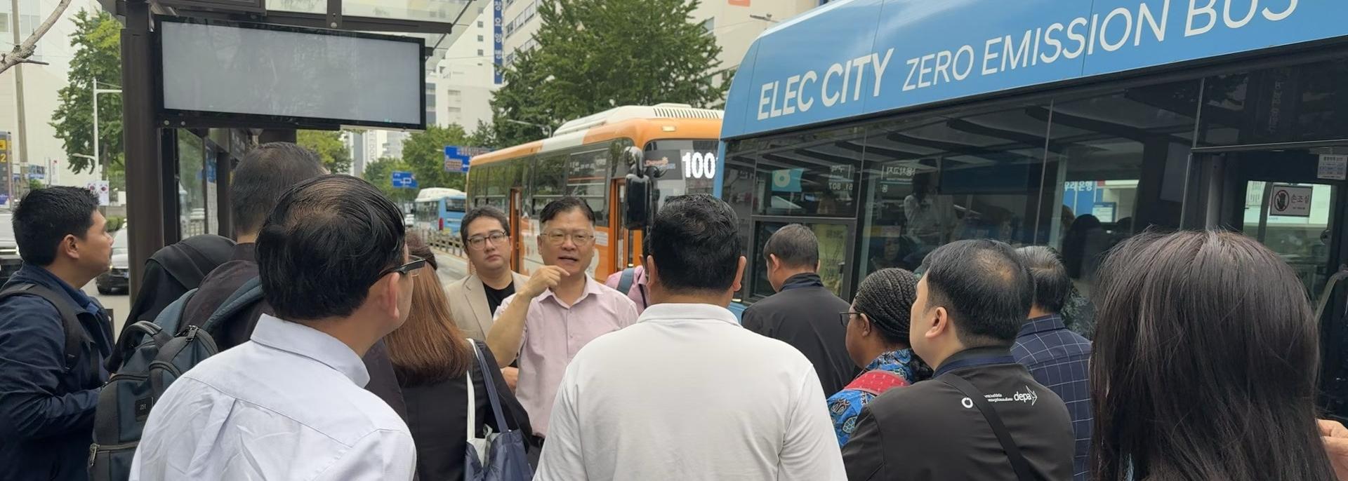 Dr. Yeong-Hyeon Hwang of Dong-A University briefs participants on Busan’s smart public transportation system at the bus stop near Busan Station. Photo credit: Jordana S Queddeng-Cosme/ADB.