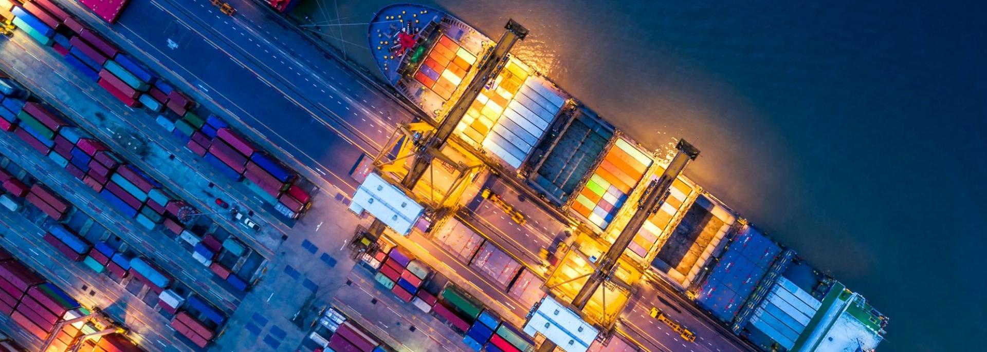 Stock photo of shipping containers and a freighter. Photo credit: iStock/thitivong.